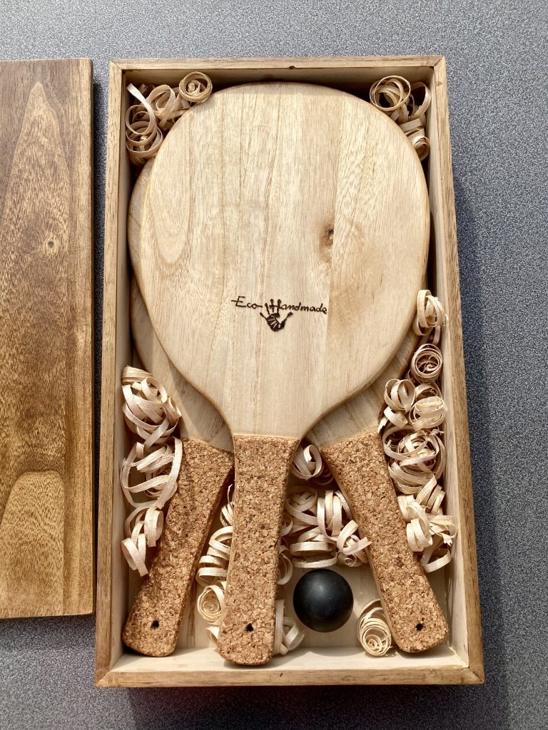 Luxury Frescobol paddle set in a wooden box, featuring two eco-friendly paulownia paddles and a squash ball, perfect for gifting or elegant storage