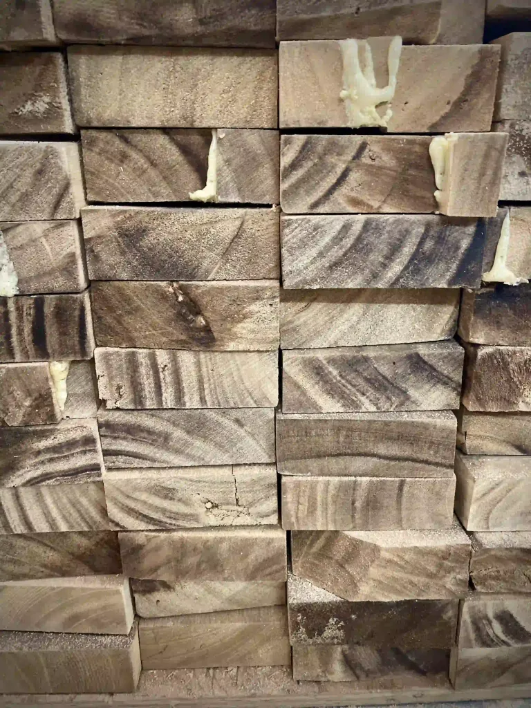 Paulownia wood blocks with natural grain patterns, showing its lightweight and fine texture. High-quality, sustainable wood ideal for surfboards and water sports