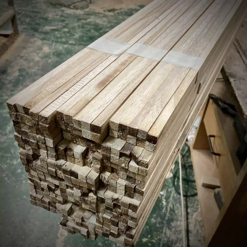 Bundle of precisely cut Paulownia wood strips, neatly stacked and ready for processing. Lightweight and durable, perfect for laminates and surfboard construction