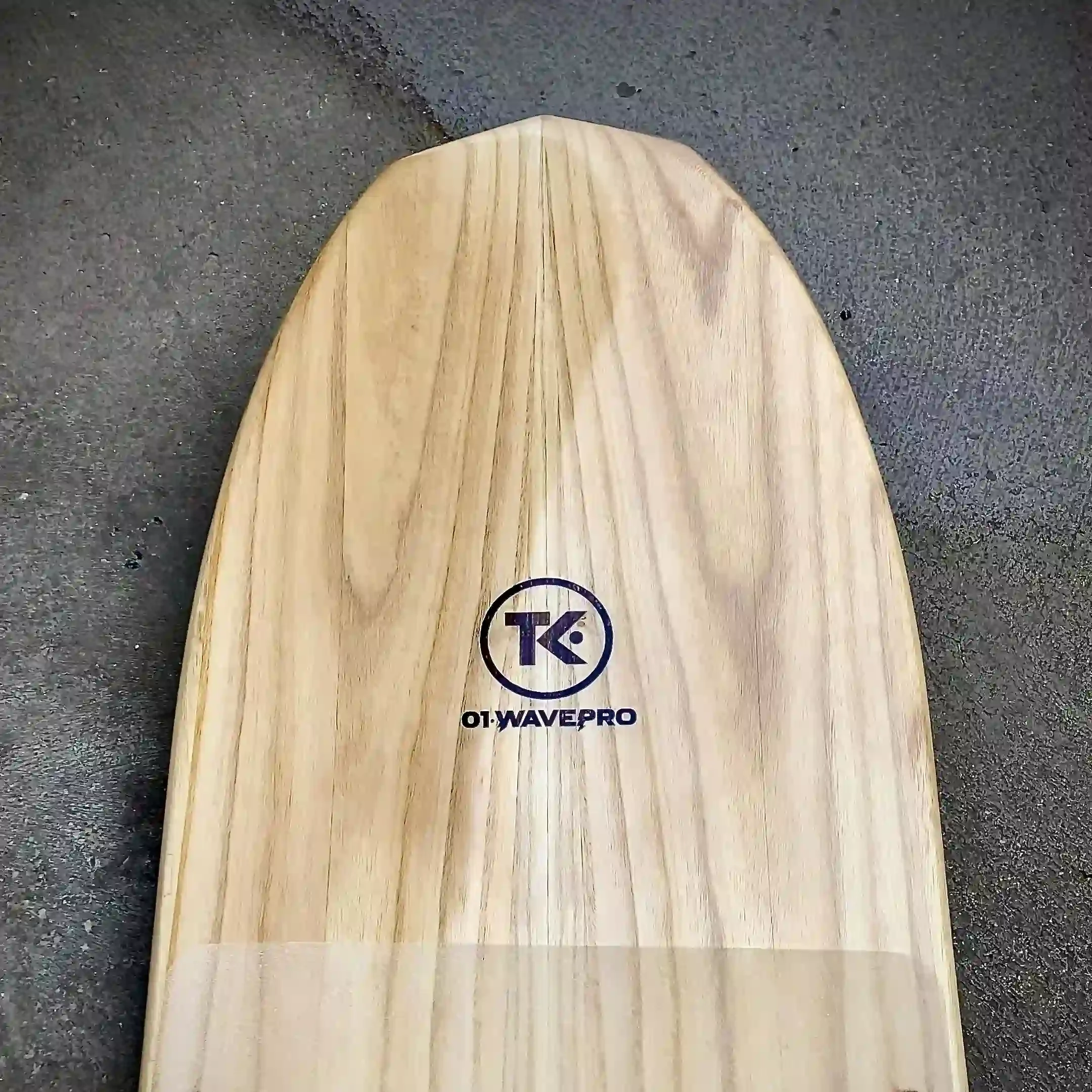 TK·03 Cruiser kiteboard nose with logo engraved on paulownia wood. TK kiteboards